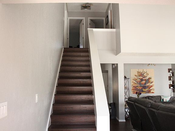 Entryway, showing living room and path to upstairs bedrooms.