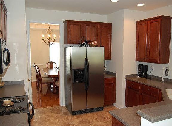 Kitchen with corian countertops and 42in cherry cabinets!