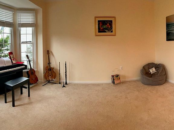 Living room to the left of the main door. Powder room is seen on the right end.
