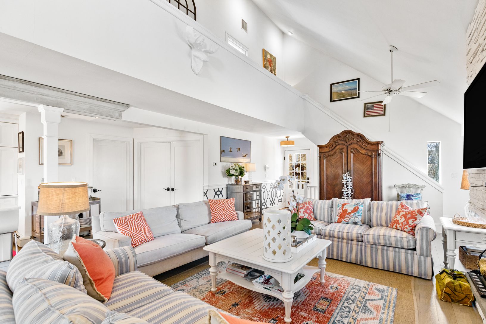  1st floor living area with large screen TV and wood burning Fireplace 