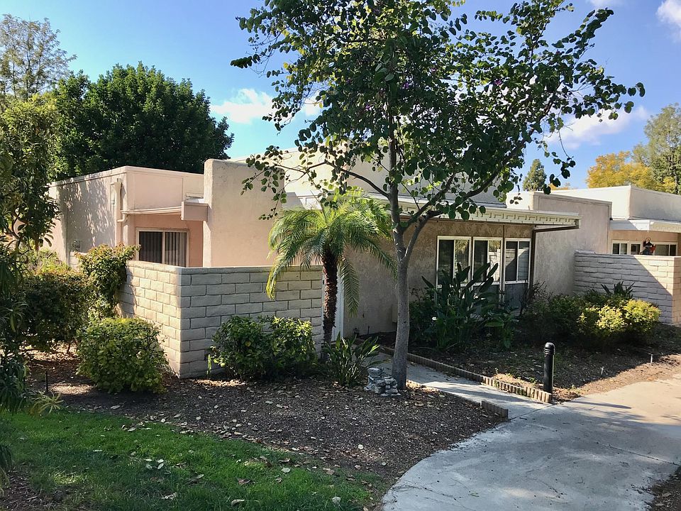 Quiet single story end manor with flat access in a garden setting.