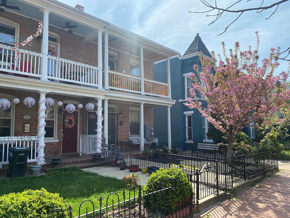 Enjoy the front yard and the blossoms of the cherry tree. The apartment is the second story end unit of the middle building with the wood stained porch.