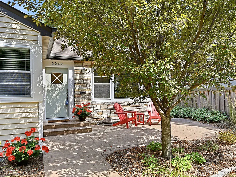 Front door with sitting area; lovely in morning or evening to watch families, dogs, and other passerby from a short distance.