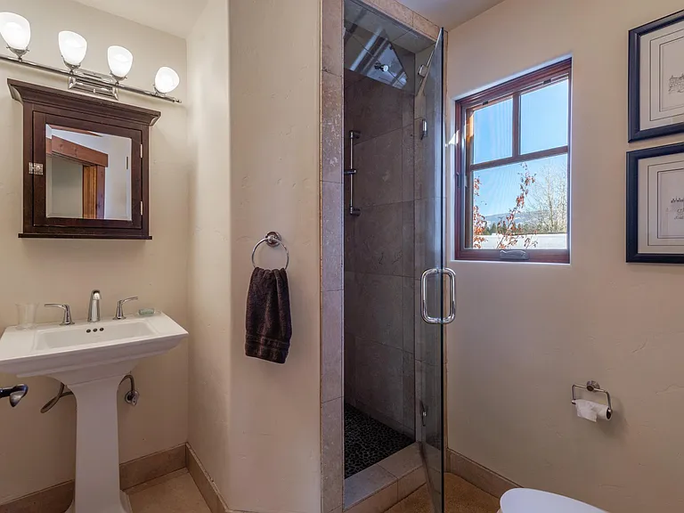 Hall bathroom with tiled shower and vanity for storage over the sink