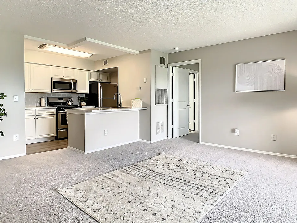 This spacious living area flows seamlessly into the kitchen, creating an inviting space for relaxing, entertaining, and enjoying everyday life at home.