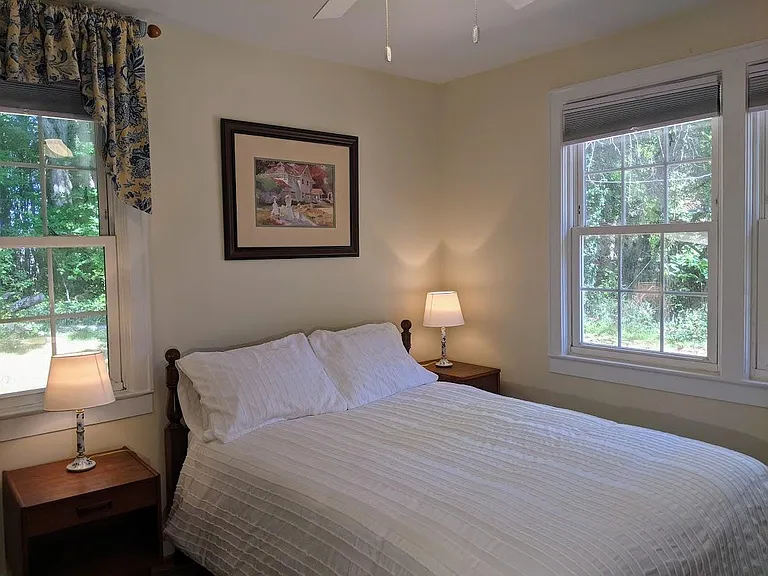 Main bedroom with double bed, dresser and double night stands.