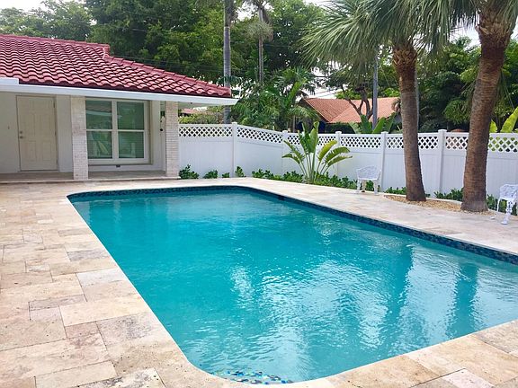 Large new pool with glass tile and marble deck