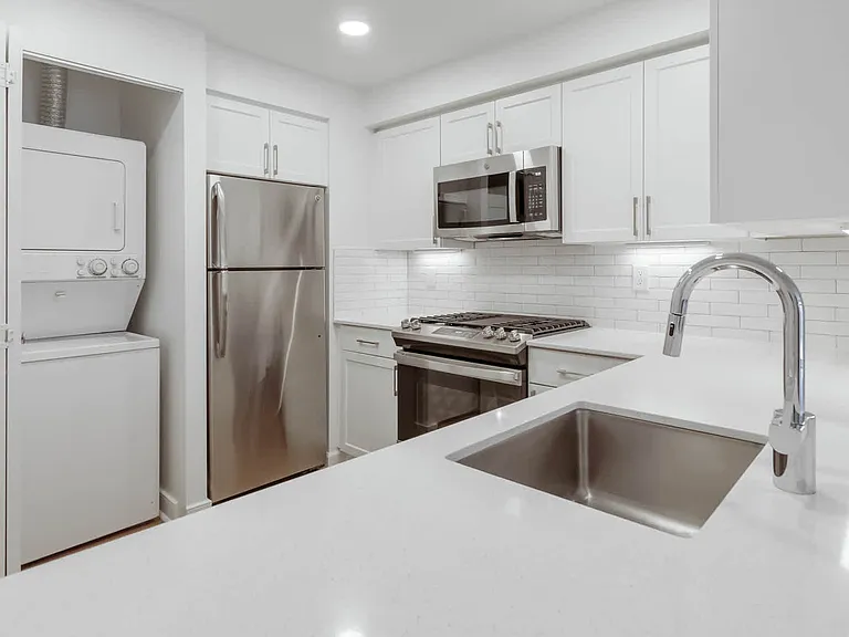 Kitchen with Stainless Steel Appliances and In-home Washer and Dryer