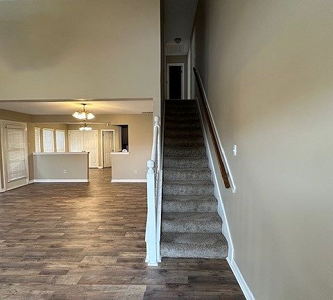 Stairs to upstairs, which has two bedrooms and 1 bathroom