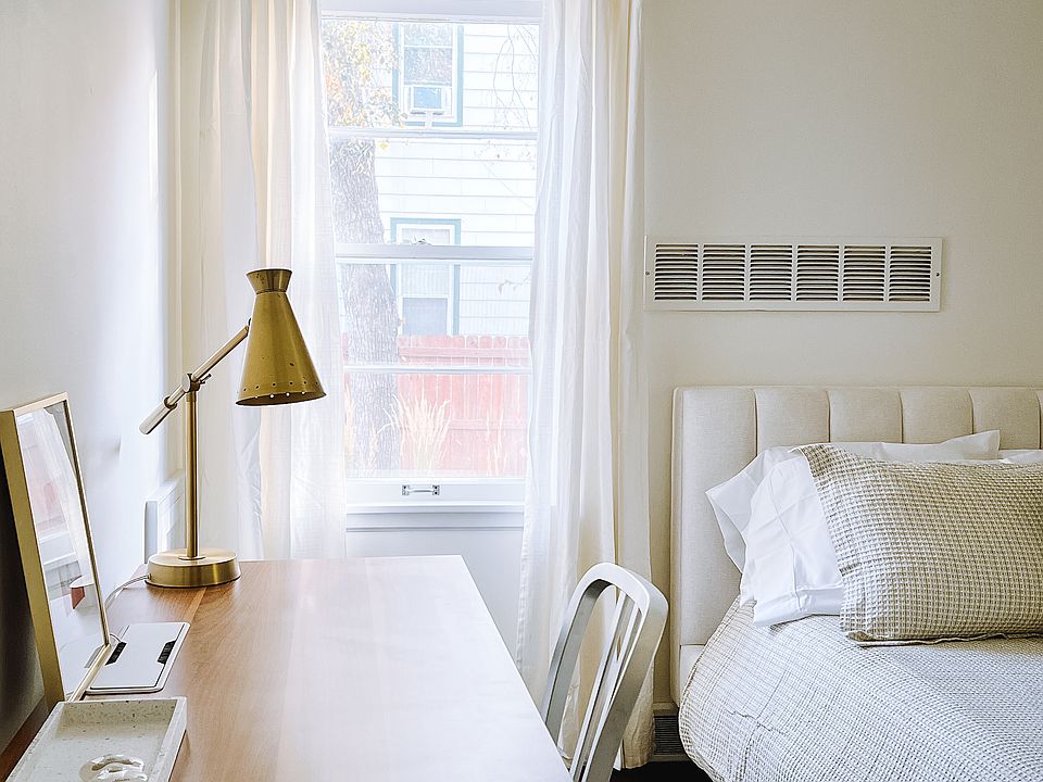 Bedroom with large desk, queen bed, and walk in closet