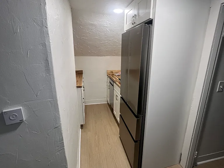 Newly remodeled kitchen w/ new refrigerator and dishwasher. A new venting skylight with shade was installed and also has electric stove.