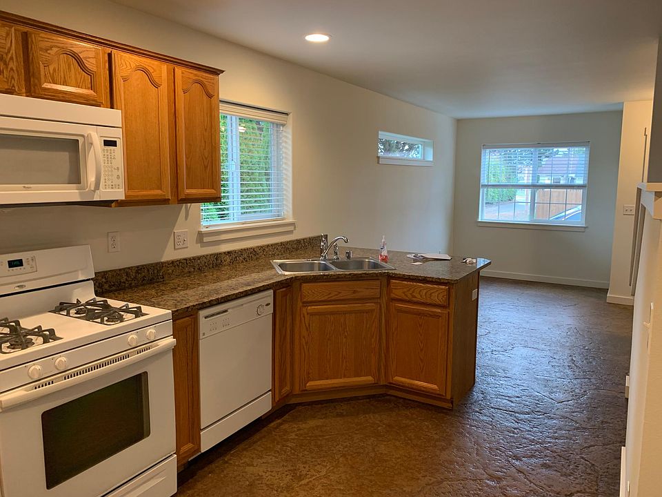 Dishwasher, microwave, gas range and refrigerator. Disposal and double sink. Radiant heat floors throughout downstairs.