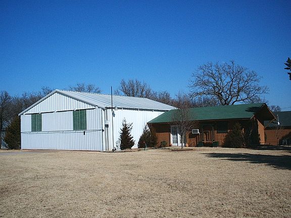 Hangar and attached apartment behind house