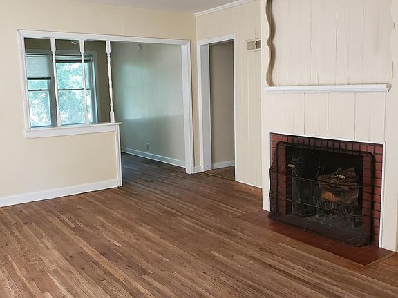 Living room showing fireplace and nice hardwood floors looking into Dining room