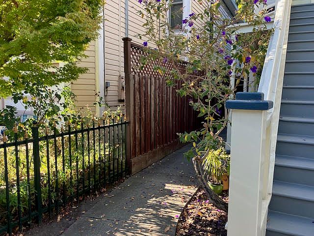 Walk down the side of the house to your front door.