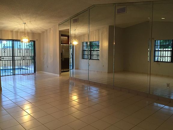 Large Living Room with Vaulted Ceilings and Full Mirrored Wa