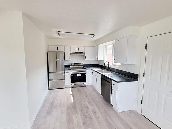 Bright kitchen with all new modern stainless steel appliances. Beautiful wood floors throughout-no carpet!
