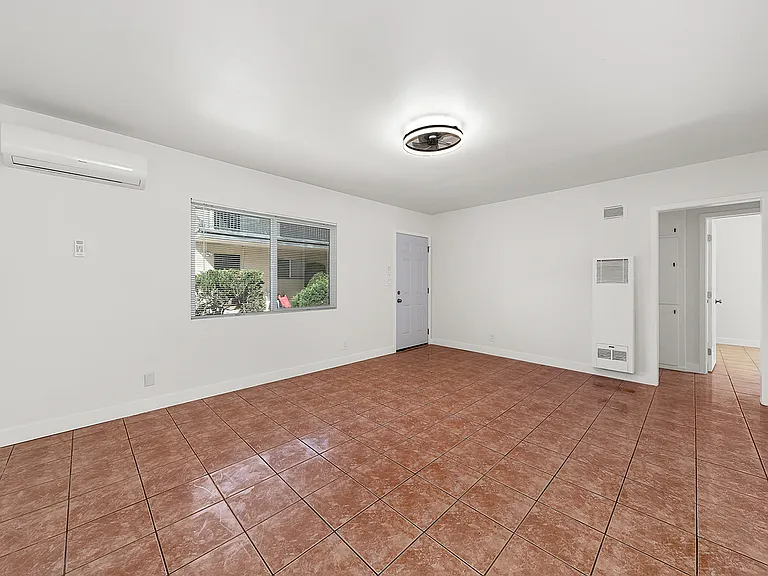 spacious living room with new split ac/heat, new windows, tile floors