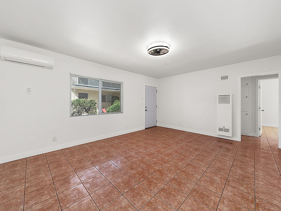 spacious living room with new split ac/heat, new windows, tile floors