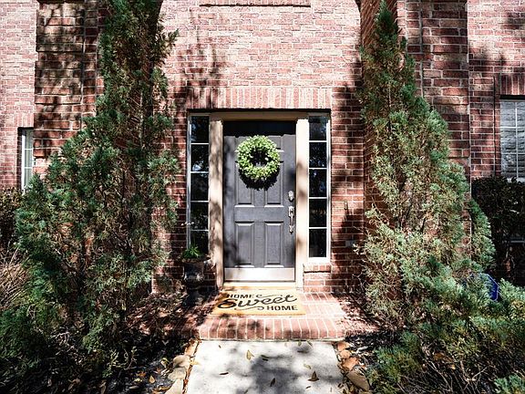 The doormat says it all - Home Sweet Home! This view of the front door speaks to those of us who love symmetry! The greenery frames the walk up & the windows frame the door perfectly.