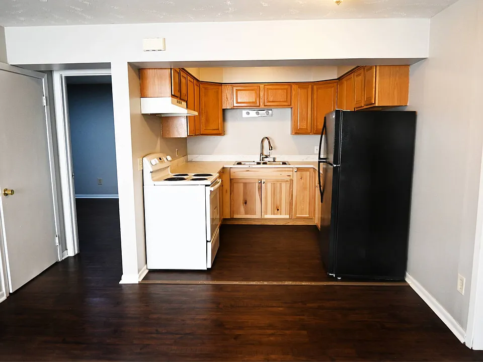 Kitchen with a bedroom of to the left.