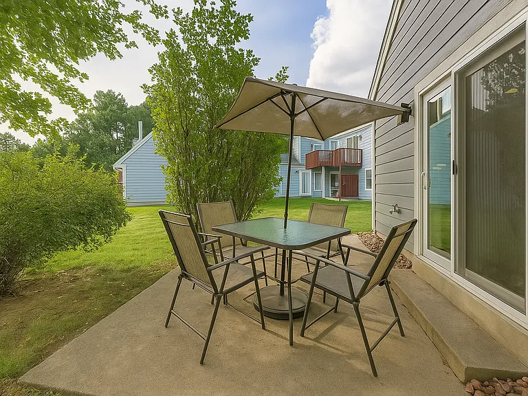 Private patio with umbrella and seating_perfect for al fresco dining or morning coffee.