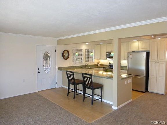 Front door & remodeled kitchen open to living room