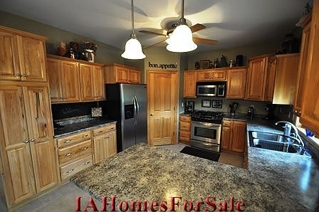 Kitchen with walk-in pantry, Hickory cabinets, and built-in pull out spice rack