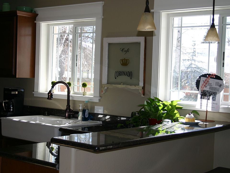 One view of kitchen-granite, double apron sink,travertine
