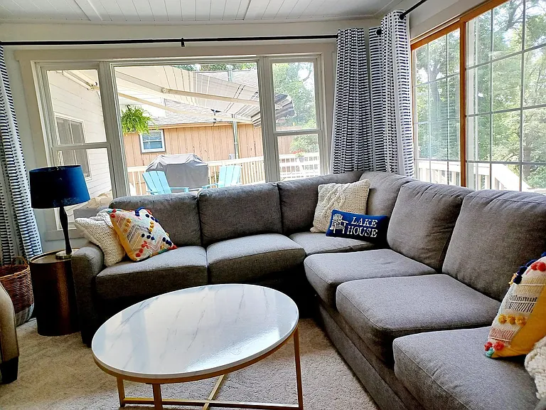 Family room with multiple windows and views of the lake.