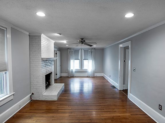 Living room with gas fireplace and original hardwood floors from 1926.