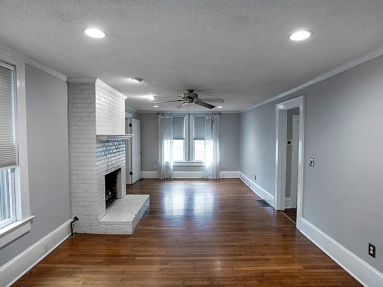 Living room with gas fireplace and original hardwood floors from 1926.