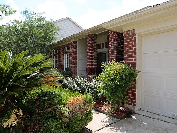 Beautifully landscaped front yard welcomes you and your gues