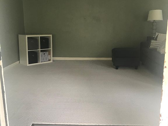 Entrance to family room with tile landing and new nylon carpeting.