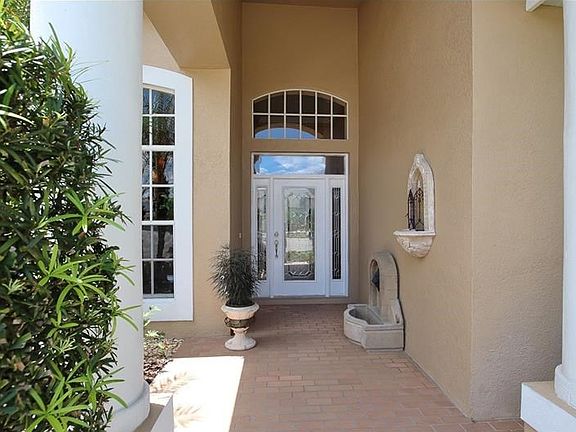 Inviting grand foyer with leaded glass door and side-light.