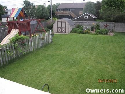 Fenced in backyard w/shed and perennials.
