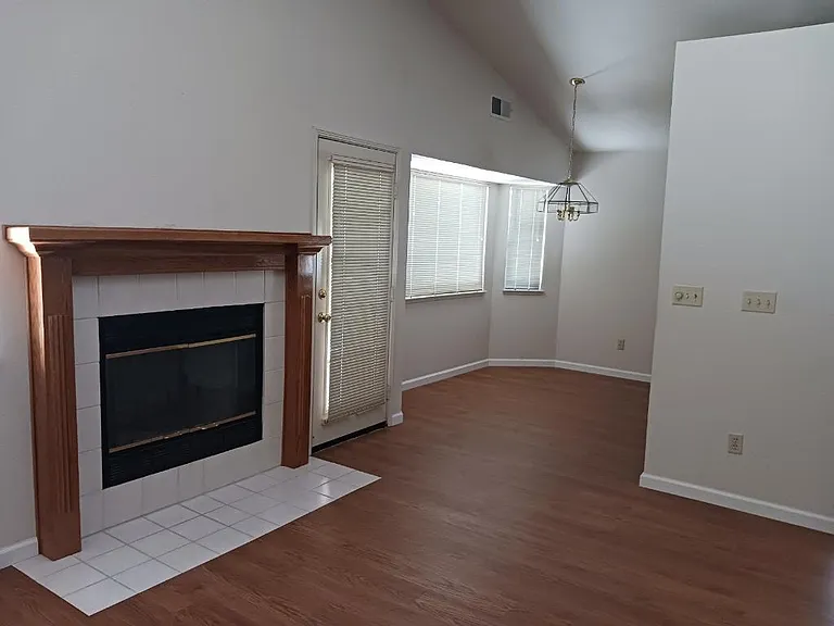 Second living room area/second dining area/door to backyard.