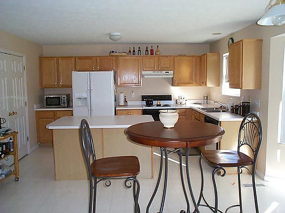 Awesome kitchen with center island with a bar for additional seating