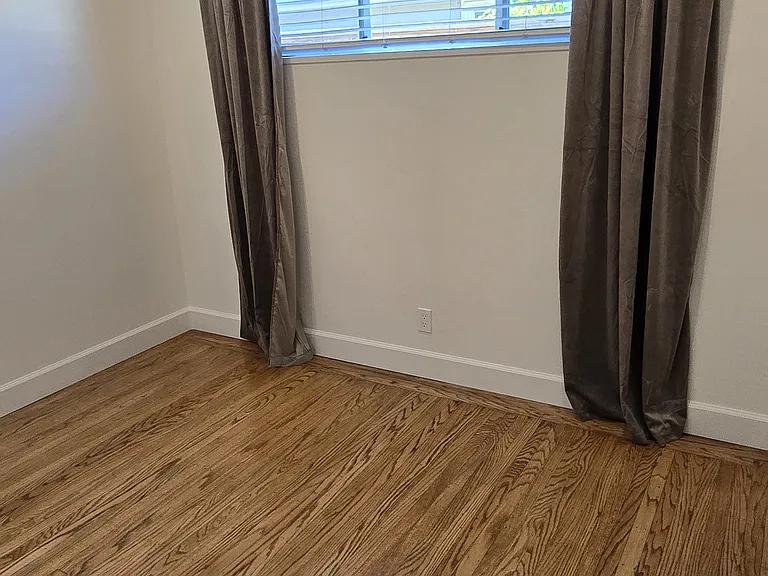 Fully functional white wood-like blinds for light filtering throughout and blackout velvet curtains. Move-in ready.