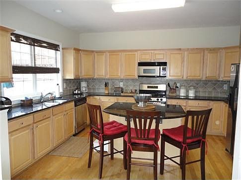 Tastefully designed granite kitchen, stainless steel appliances, and large island - all open to the 