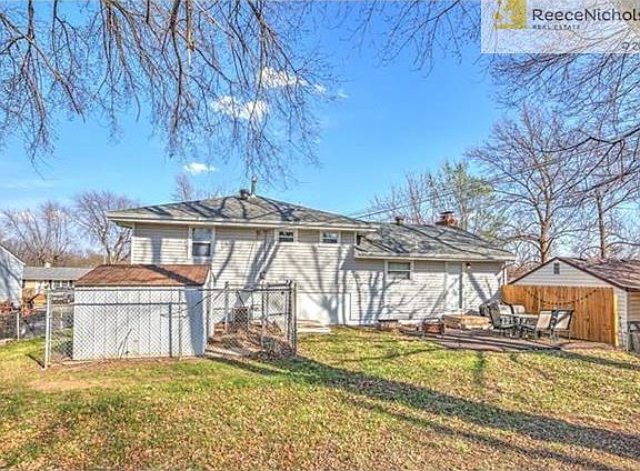 REAR VIEW OF HOME WITH TWO PATIOS,SHED AND FENCE