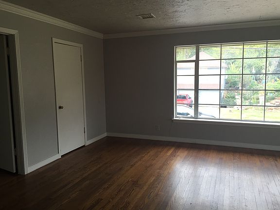 living room/ large bay window/ wood floors
