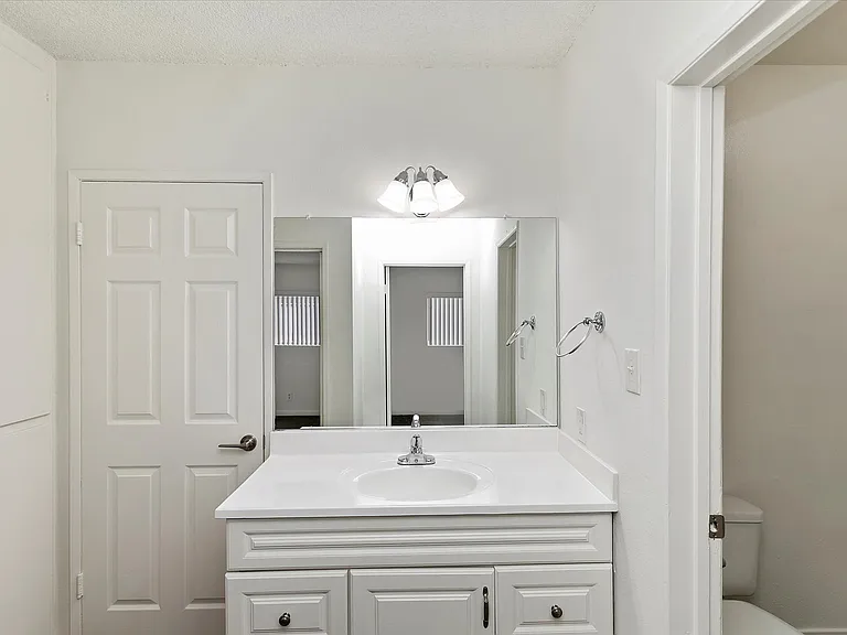 vanity sink outside of both bedrooms