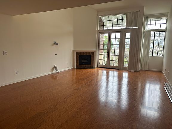 Spacious Living Room - Lots of natural light with high ceilings and entertainment wiring built into wall (dining room not pictured)