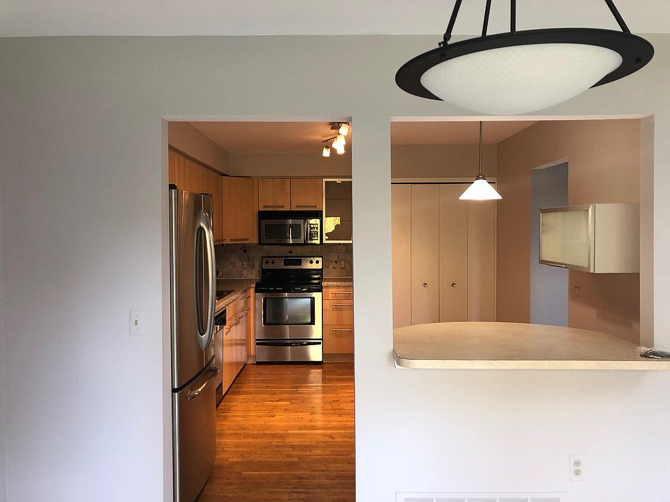 Spacious Kitchen with hardwood floors, upgraded cabinets and stainless steel appliances and breakfast nook