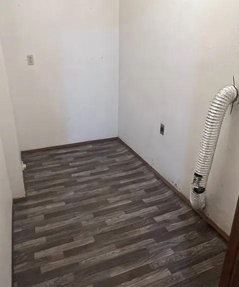Laundry room downstairs with washer/dryer hook-ups. New flooring