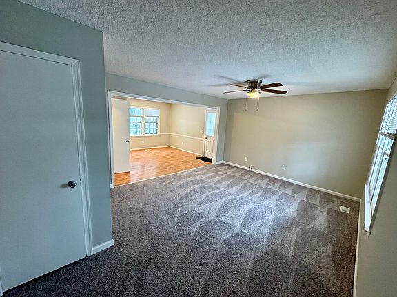 Enter into living room from front door. Coat closet to left.