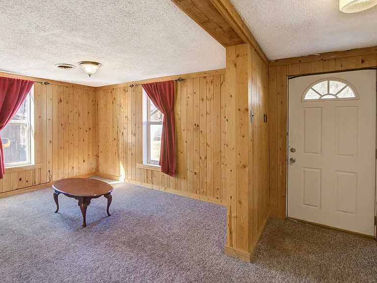 In the home's SW front corner is the living area, also with windows facing 5th St and mountain views.
