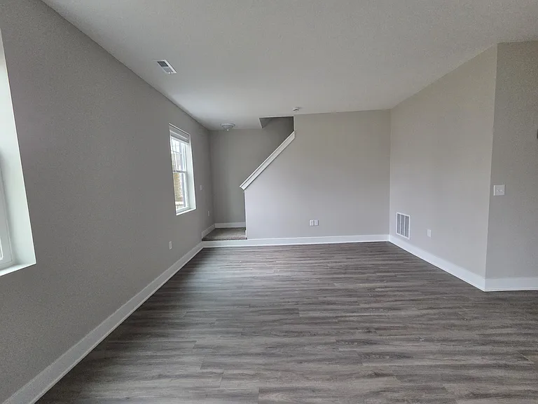 Townhome living area and stairs leading to second level.
