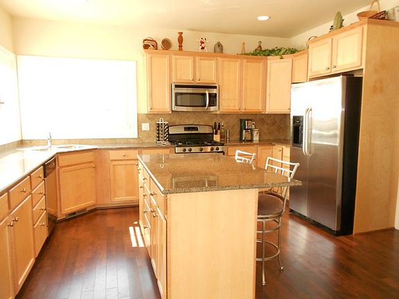 Kitchen with granite counters, custom cabinets and breakfast bar.